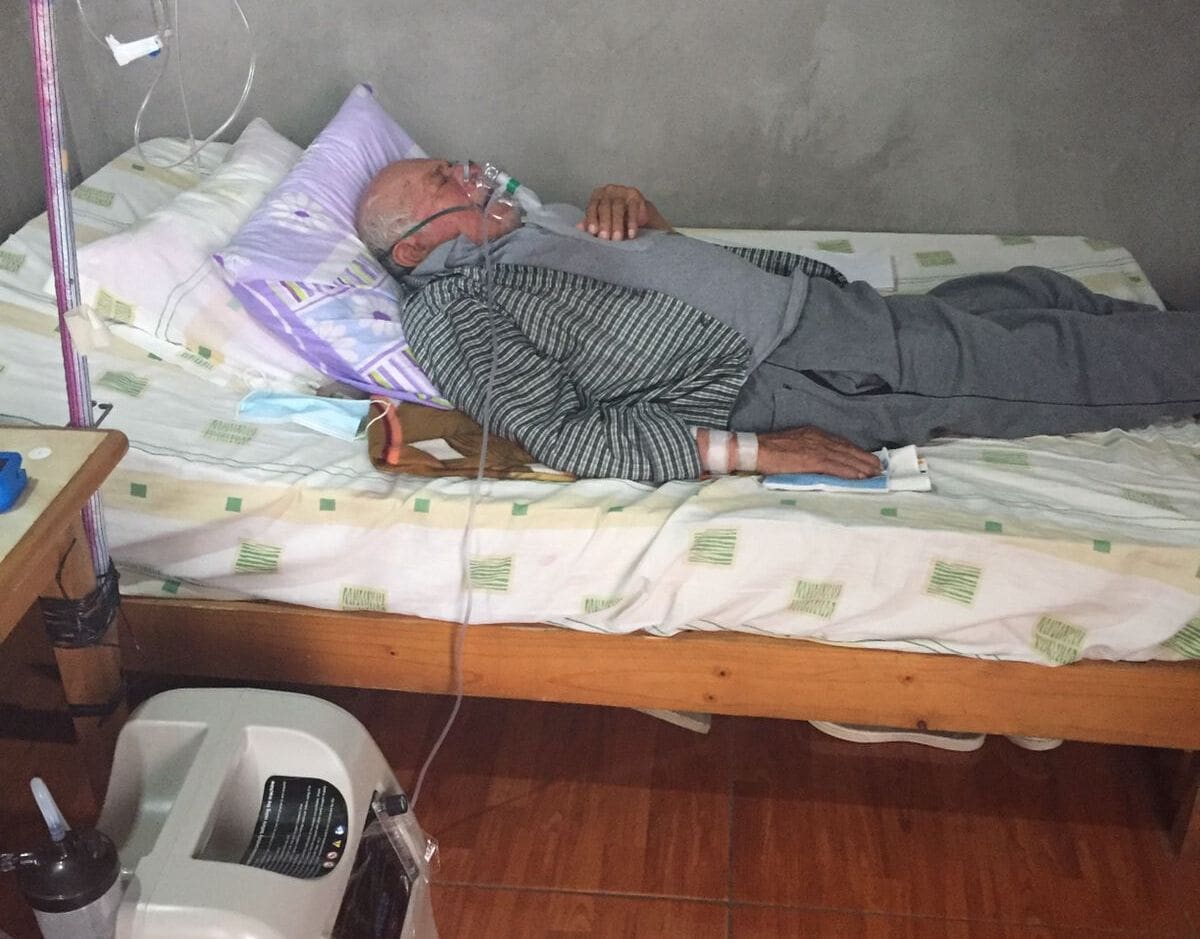 A man laying in bed with his head on the pillow.