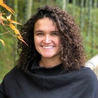 A woman with long hair and a black sweater.